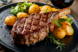 Perfectly grilled steak served with crispy, golden roasted potatoes and fresh herbs.