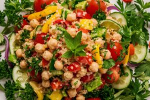 Quinoa and chickpea salad with fresh vegetables, herbs, and a light dressing.